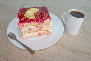 A piece cake on dish with currant in a relaxing time. Cake with red currant