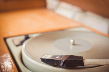 Fototapeta na wymiar Close up of old worn vintage record player. Retro filter effect.