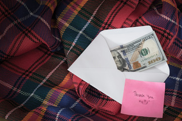 Money in a white envelope, put on a blanket, along with a thank you message.