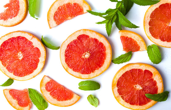 Grapefruit slices and mint leaves isolated