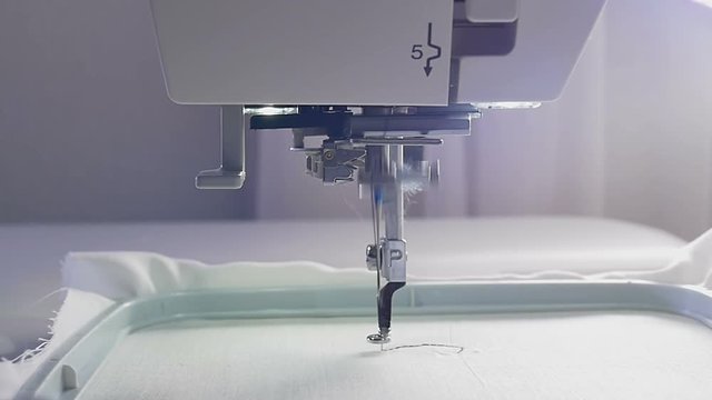 Machine embroidery work.Working embroidery machine. Textile - Professional and industrial embroidery machine. Needle moves quickly, embroidering a pattern