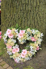 Sympathy flowers near a tree