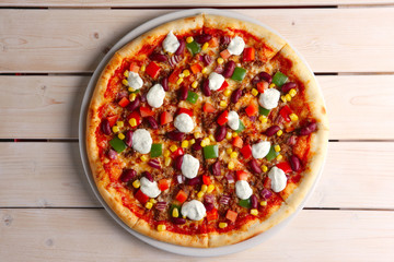 Top view of pizza with bean, mozzarella, pepper and corn