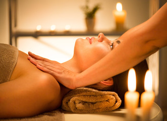 Spa. Beauty brunette woman enjoying relaxing body massage in spa salon