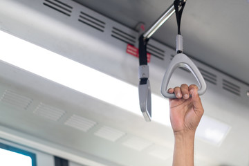 People Hand holding Handle on the train