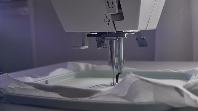 Machine embroidery work.Working embroidery machine. Textile - Professional and industrial embroidery machine. Needle moves quickly, embroidering a pattern