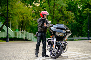 Rider and his black custom motorbike 