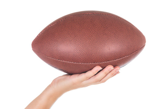 Female Hand Holding Tan Rugby Ball Isolated On White Background