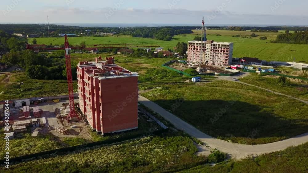 Wall mural Aerial view of multi-storey building construction at summer time