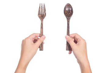 Hand holding wooden spoon and fork isolated on white background