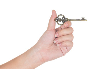 woman's hand holding an antique key isolated on white background