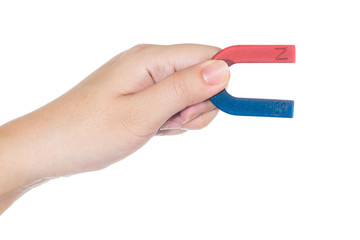 Female hand holding red and blue magnet  isolated on white background