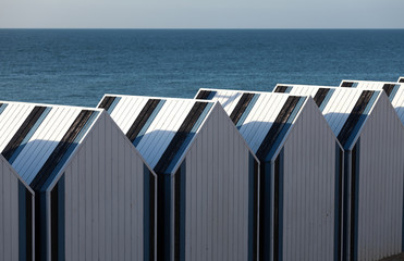 Black and white striped wooden beach chalets at Yport, Normandy, northern France