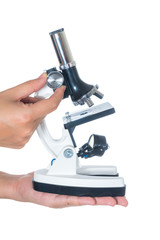 Female hand holding white science microscope isolated on white background