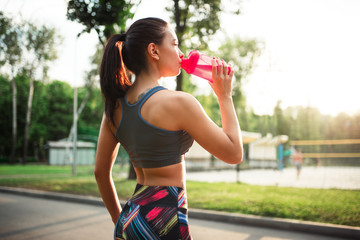 Woman drink water from sport bottle