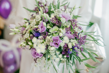 Beautiful purple wedding bouquet in bride's hands