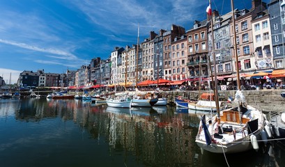 Fototapeta na wymiar Editorial Honfleur, France - July 05, 2017: Honfleur harbour in France's Normandy region, sited on the estuary where the Seine river meets the English Channel