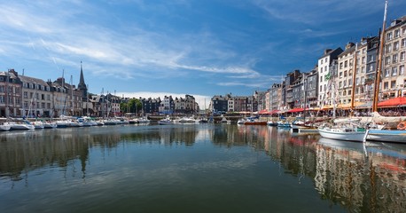 Fototapeta na wymiar Editorial Honfleur, France - July 05, 2017: Honfleur harbour in France's Normandy region, sited on the estuary where the Seine river meets the English Channel