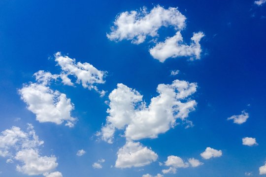 Isolated white clouds on blue sky. Set of isolated clouds over blue background. Design elements. White isolated clouds. Cutout extracted clouds