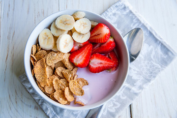 Healthy Breakfast which included cornflakes and oatflakes, yogurt, bananas and strawberries