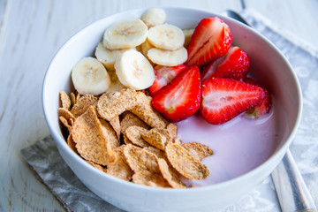 Healthy Breakfast which included cornflakes and oatflakes, yogurt, bananas and strawberries