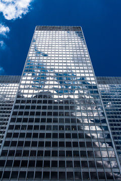 Low angle view of modern buildings exterior with clouds