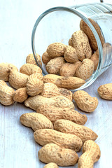 crude peanuts on the wooden background