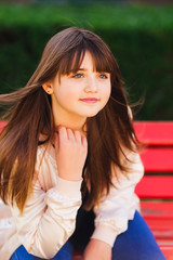 Fototapeta premium Pretty teenager looking thoughtful on bright background
