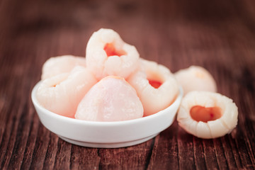 Wooden table with Preserved Lychees (selective focus)