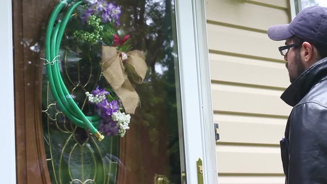 A woman is served at her house by a process server in disguise