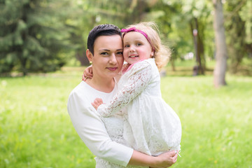 Mom and daughter spend time together in the park in the summer