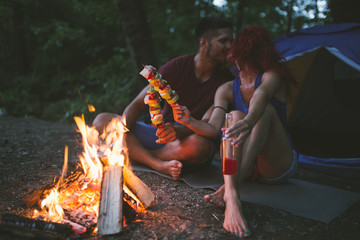 Fototapeta na wymiar Young happy couple enjoying camping and hiking in wild nature.