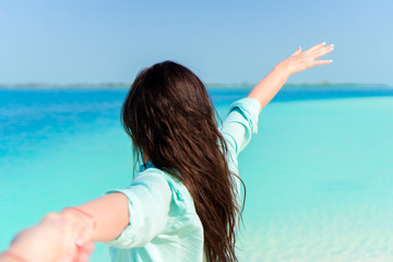 Fototapeta na wymiar Young beautiful woman on tropical seashore. Back view of young girl background the sea