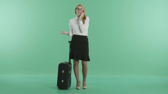 a woman has a phone call holding a luggage