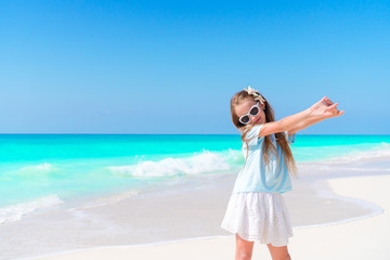 Fototapeta na wymiar Portrait of adorable little girl outdoors on the beautiful tropial beach