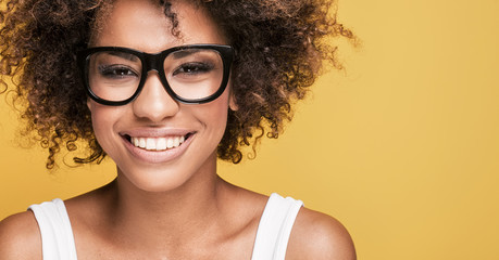 African american girl wearing eyeglasses,smiling. - obrazy, fototapety, plakaty