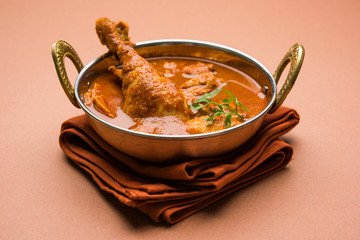 Indian spicy Chicken curry or masala chicken with prominent leg piece, popular recipe from India, selective focus
