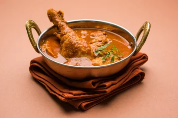  Indian spicy Chicken curry or masala chicken with prominent leg piece, popular recipe from India, selective focus   © StockImageFactory