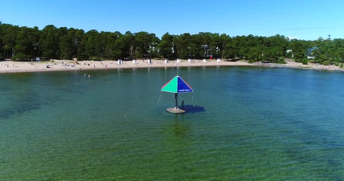 Hanko beach, Cinema 4k aerial view over the water carousel and plagen beach, on hango regatta day, in the finnish archipelago city Hanko, Finland