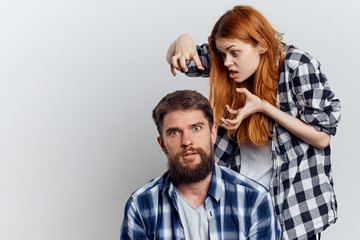 Young beautiful woman and guy with beard on white isolated background, repair, building materials, tools