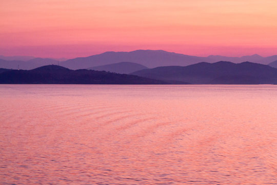 Rosy Dawn of Pink and Purple Tones with Distant Mountains, Somewhere on the Adriatic Sea, Greece Islands Cruise