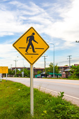 Pedestrian cross warning traffic sign on road