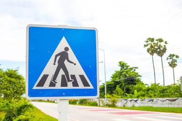 Pedestrian cross warning traffic sign on road