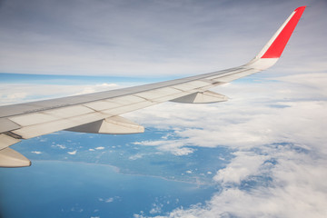 Fototapeta premium Beautiful view of Land and sea from a plane window view.