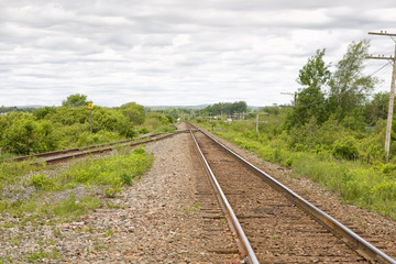 Fototapeta na wymiar Single train track with siding in rural setting