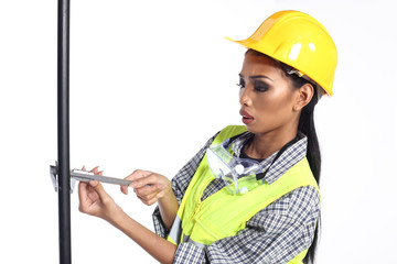 Asian Architect Engineer woman in yellow hard hat,  safety vast equipment, thick gloves, protector glasses goggle and equipment