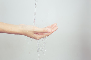 Fototapeta premium The Asian girl's hands are splashed with water.on white background