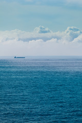 Seascape, ship on sea, horizon and sky.