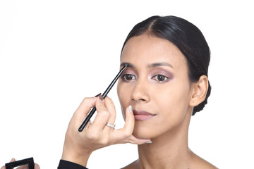 Fototapeta premium Asian Tan Skin Woman wtih Hand On applying cosmetic, Start from fresh face to finish process, studio lighting white background isolated copy space, Series pack photo 