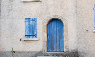 Fototapeta na wymiar Provence style blue wooden doors and window shutters